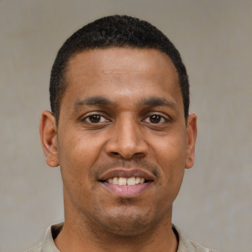 Joyful latino young-adult male with short  black hair and brown eyes