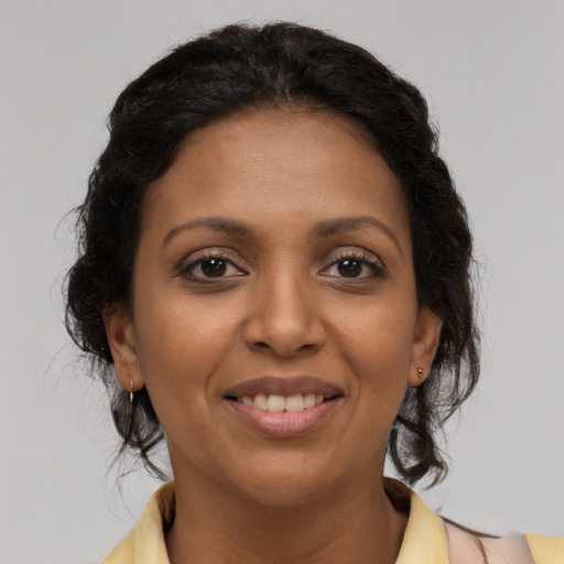 Joyful latino young-adult female with medium  brown hair and brown eyes