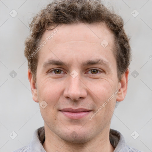 Joyful white adult male with short  brown hair and grey eyes