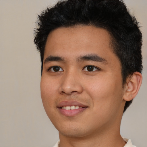 Joyful asian young-adult male with short  black hair and brown eyes