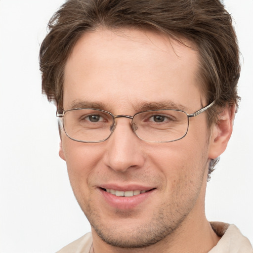 Joyful white adult male with short  brown hair and grey eyes