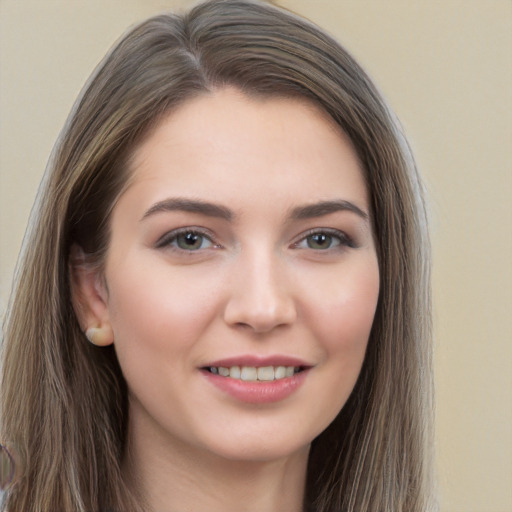 Joyful white young-adult female with long  brown hair and brown eyes