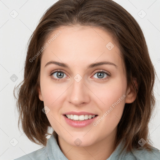 Joyful white young-adult female with medium  brown hair and blue eyes