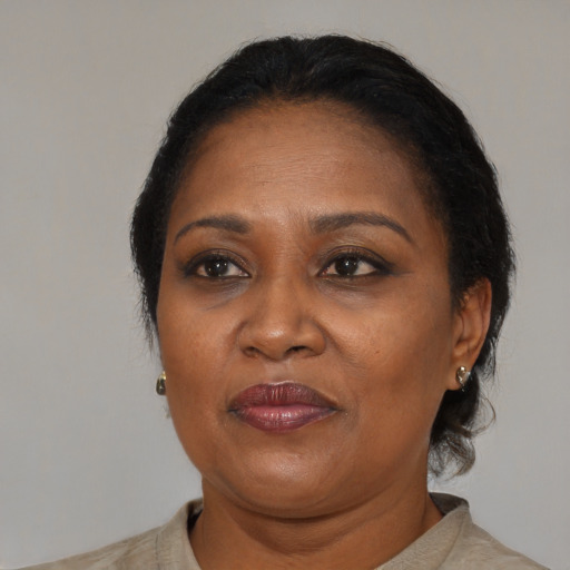Joyful black adult female with medium  brown hair and brown eyes