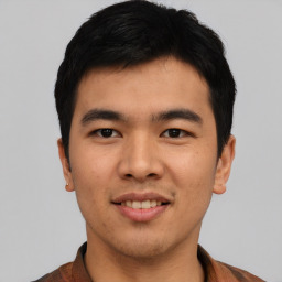 Joyful asian young-adult male with short  black hair and brown eyes