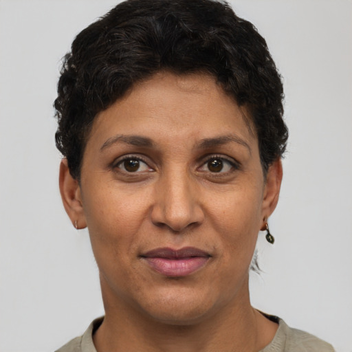 Joyful latino adult female with short  brown hair and brown eyes