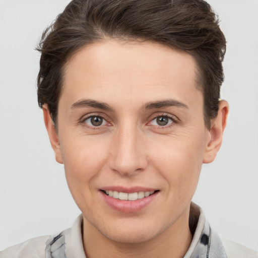 Joyful white young-adult female with short  brown hair and brown eyes