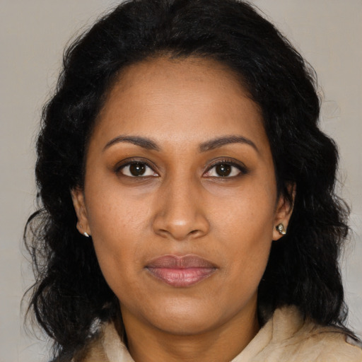 Joyful black adult female with medium  black hair and brown eyes