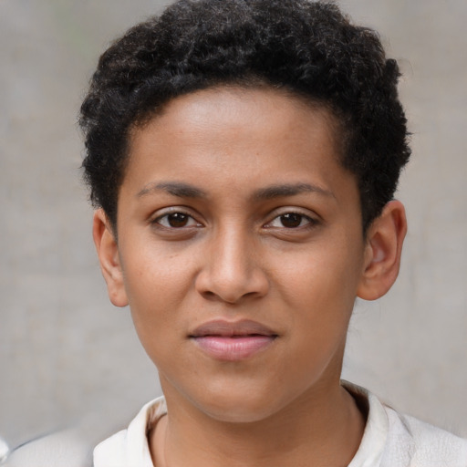 Joyful black young-adult female with short  brown hair and brown eyes