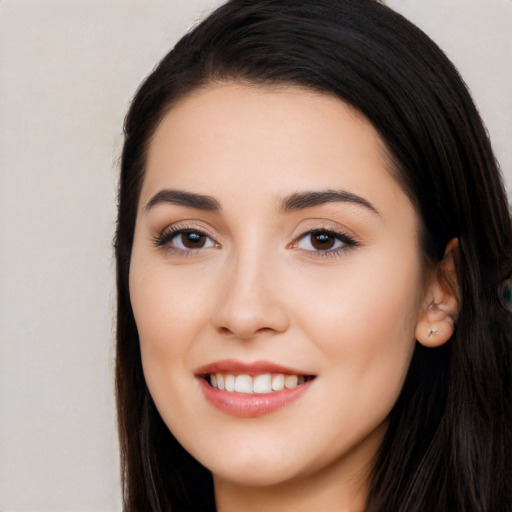 Joyful white young-adult female with long  black hair and brown eyes