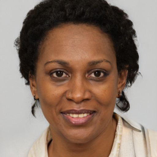 Joyful black adult female with short  brown hair and brown eyes