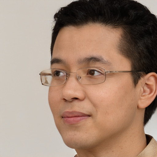 Joyful asian adult male with short  brown hair and brown eyes