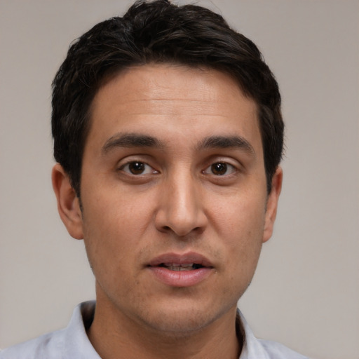 Joyful white young-adult male with short  black hair and brown eyes