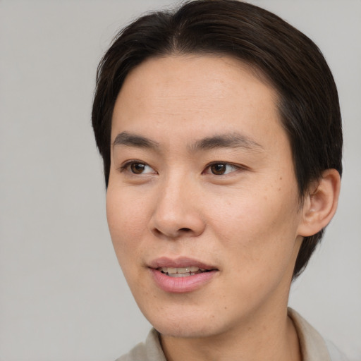 Joyful asian young-adult male with short  brown hair and brown eyes