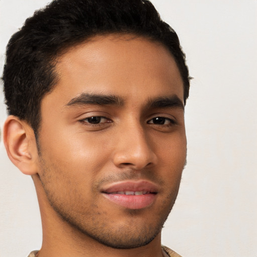 Joyful latino young-adult male with short  brown hair and brown eyes