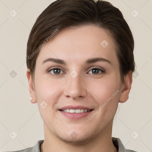 Joyful white young-adult female with short  brown hair and grey eyes