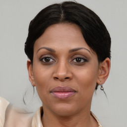 Joyful latino adult female with medium  brown hair and brown eyes