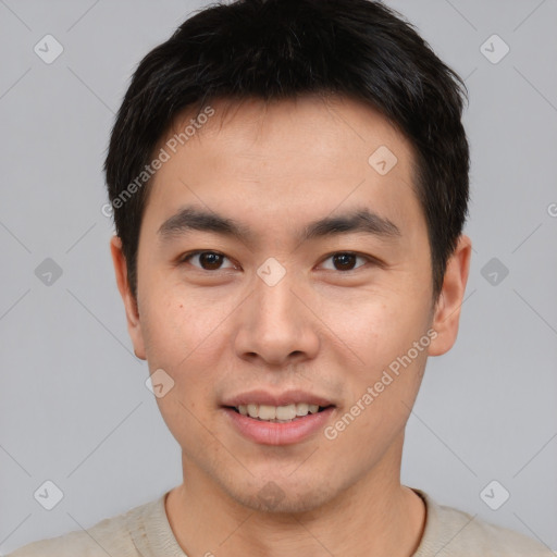 Joyful asian young-adult male with short  black hair and brown eyes