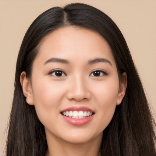 Joyful white young-adult female with long  black hair and brown eyes