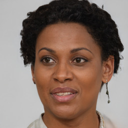 Joyful black adult female with short  brown hair and brown eyes