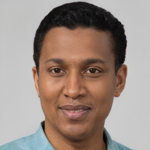 Joyful black adult male with short  black hair and brown eyes