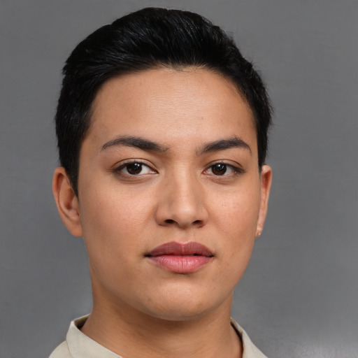 Joyful latino young-adult female with short  black hair and brown eyes