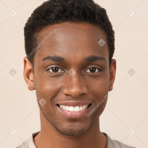 Joyful black young-adult male with short  brown hair and brown eyes