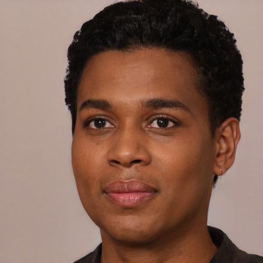 Joyful black young-adult male with short  black hair and brown eyes