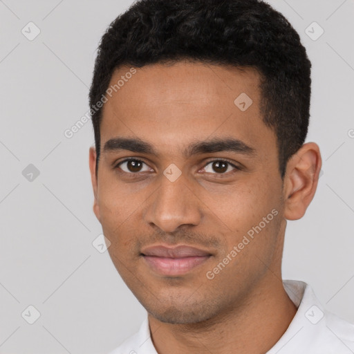 Joyful black young-adult male with short  black hair and brown eyes