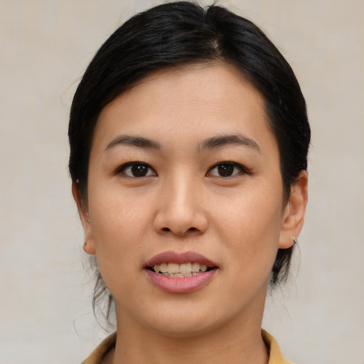 Joyful asian young-adult female with medium  black hair and brown eyes