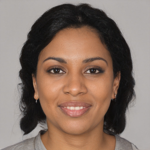 Joyful black young-adult female with medium  black hair and brown eyes