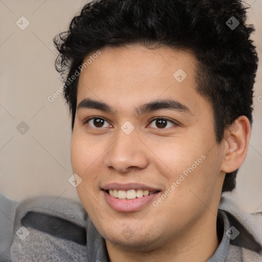 Joyful latino young-adult male with short  brown hair and brown eyes