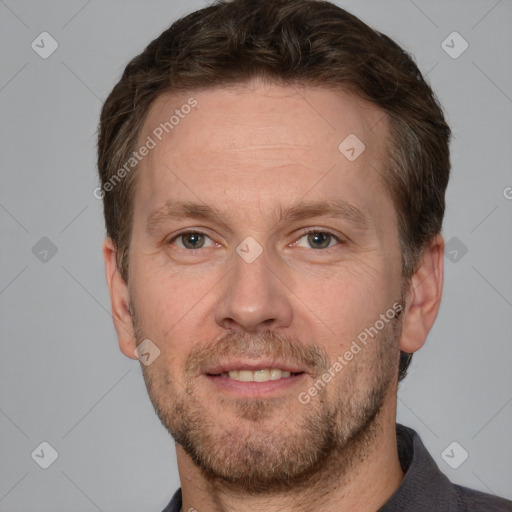 Joyful white adult male with short  brown hair and grey eyes