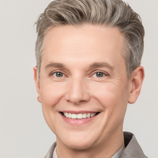 Joyful white adult male with short  brown hair and grey eyes