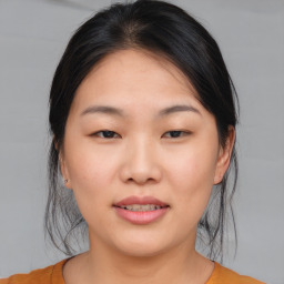 Joyful asian young-adult female with medium  brown hair and brown eyes