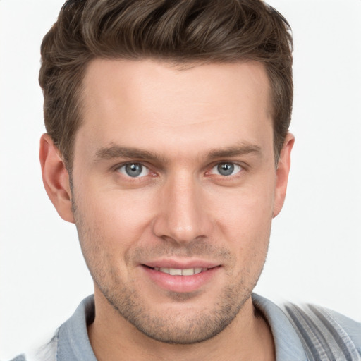 Joyful white young-adult male with short  brown hair and grey eyes