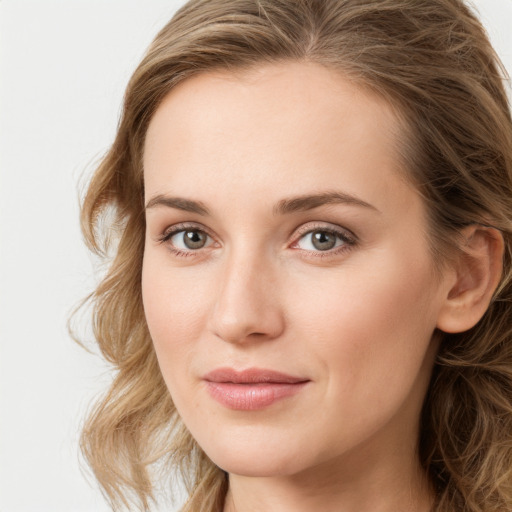 Joyful white young-adult female with long  brown hair and blue eyes