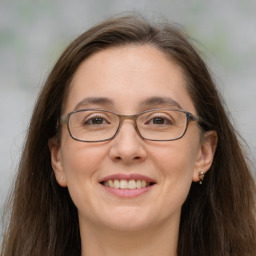 Joyful white adult female with long  brown hair and brown eyes