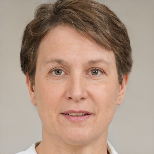 Joyful white adult female with short  brown hair and grey eyes