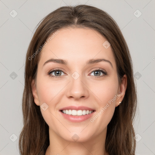 Joyful white young-adult female with long  brown hair and green eyes