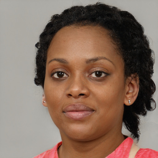 Joyful black young-adult female with medium  black hair and brown eyes