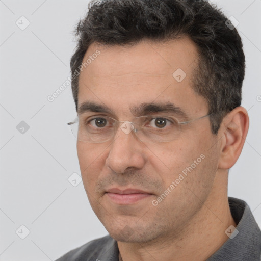 Joyful white adult male with short  black hair and brown eyes