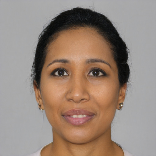 Joyful latino young-adult female with short  black hair and brown eyes