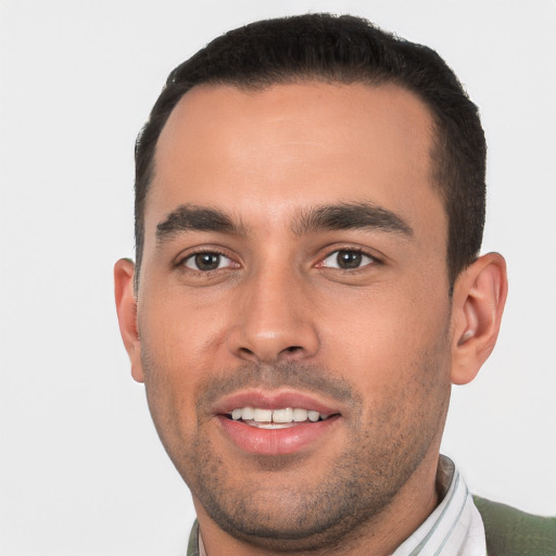 Joyful white young-adult male with short  black hair and brown eyes