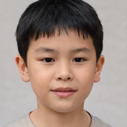Joyful asian child male with short  brown hair and brown eyes