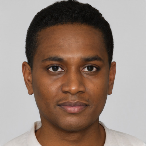 Joyful black young-adult male with short  black hair and brown eyes