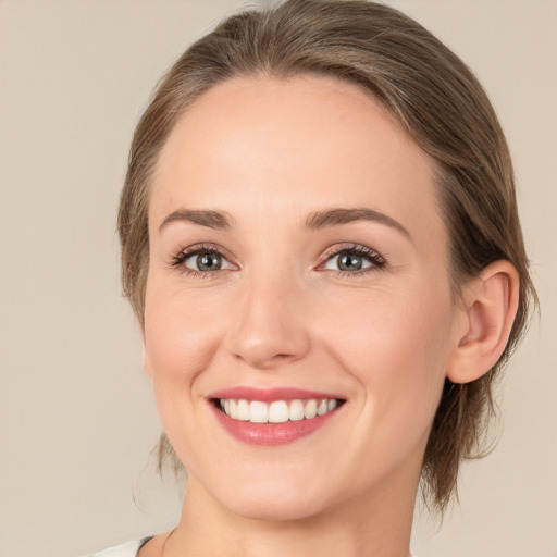 Joyful white young-adult female with medium  brown hair and green eyes