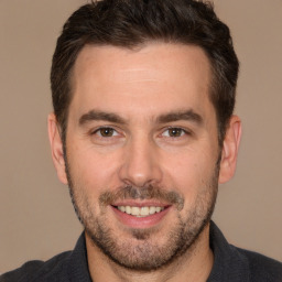 Joyful white adult male with short  brown hair and brown eyes