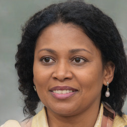 Joyful black adult female with medium  brown hair and brown eyes