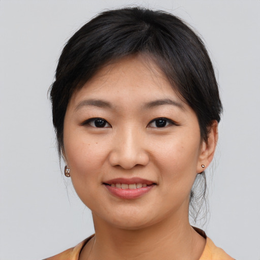 Joyful asian young-adult female with medium  brown hair and brown eyes